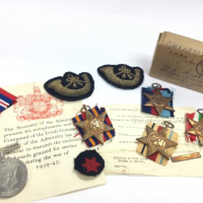 A collection of WW2 medals including The Burma Star, The Africa Star, The Italy Star, The 1939-1945 Star, cap badges, commemorative medals etc. postage category A