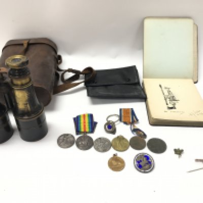 A collection of assorted medals and badges including a 9ct gold example. Lot including book with some hand sketches and also a set of binoculars. Postage B