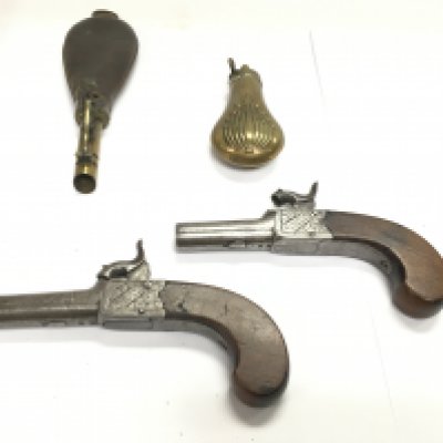 A pair of English percussion cap pistols with walnut grips. Marked Fenton London. Also two powder flasks. Postage B