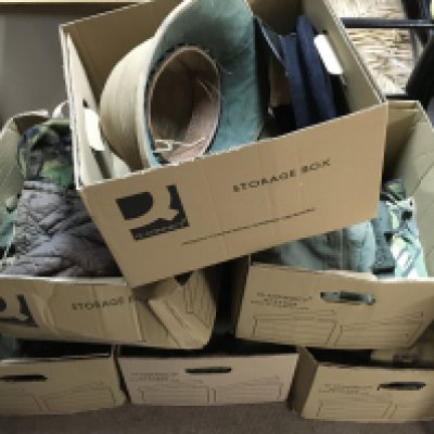 A collection of military uniforms including hats, combat trousers, bags etc. This lot cannot be posted