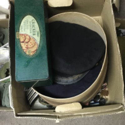 An assortment of military costumes including hats, clothing and other military items such as cap badges, ribbons etc