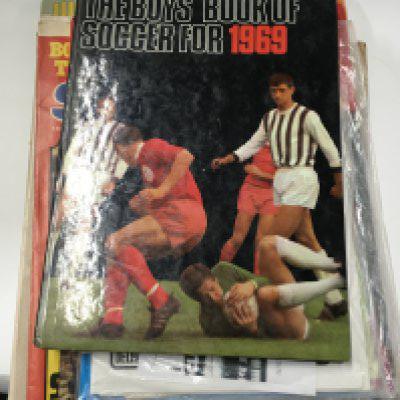 A small collection of football sticker books.