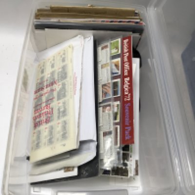 A box containing great Britain presentation packs, covers and loose stamps.
