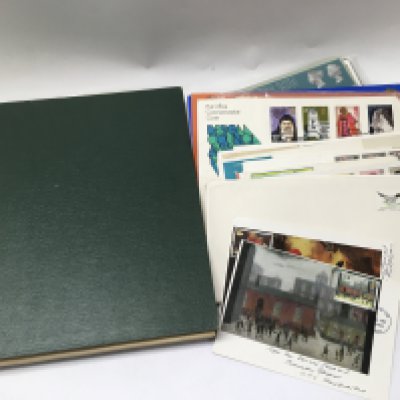 An album of British and world stamps also including some loose stamps.