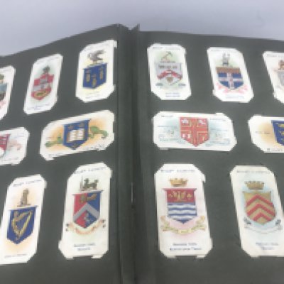 Four albums containing cigarettes cards including football,