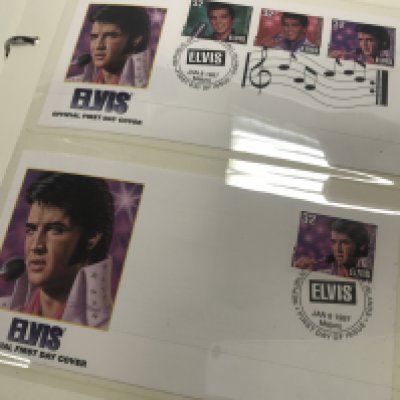 A collection of world stamps together with Elvis first day issue .
