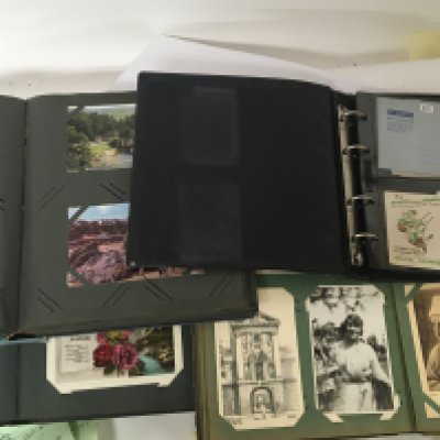 A Collection of postcards and early postal covers in albums.