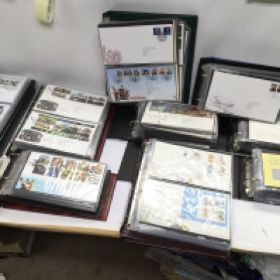 A large collection of assorted first day covers including Wallace and gromit Alice in Wonderland etc.
