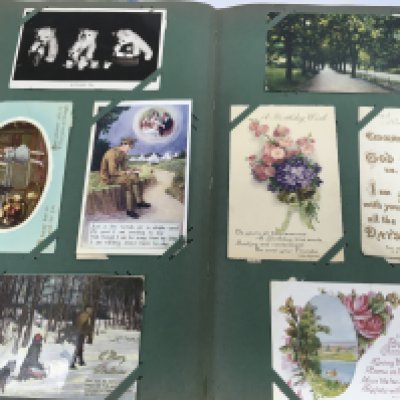 A album containing Edwardian and later postcards.