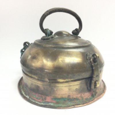 A brass round container with chain hinges and a brass handle. 14cm tall approximately. Postage category B