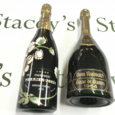 A bottle of Perrier Jouet 1973 champagne and a bottle of 1964 Dom Ruinart Brut champagne. Postage D