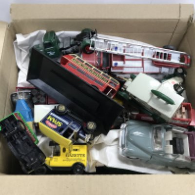 A box containing die cast cars and other die cast vehicles.