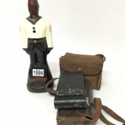 A Vintage bottle in the form of a sailor figure and two old cameras (3)