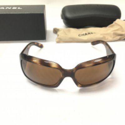 A pair of Chanel sunglasses with both case and outer box. Postage B