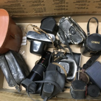 Vintage cameras including a Zenit-E, Halina, Zenit EM. Mirage zoom lens, Ajax 7x50 binoculars. This lot cannot be posted