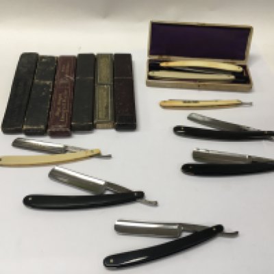 A collection of 9 vintage straight razors with cases.