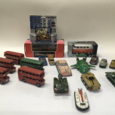 A collection of various die cast cars and buses and some boxed buses and cars.