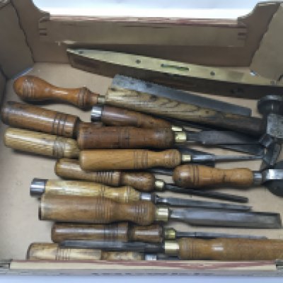 A collection of vintage chisels and other tools.
