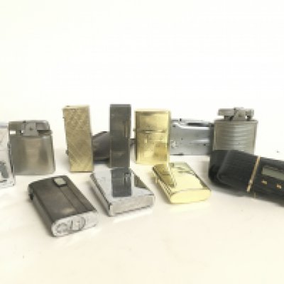 A collection of Vintage lighters and a Time master travel clock, this lot cannot be posted.