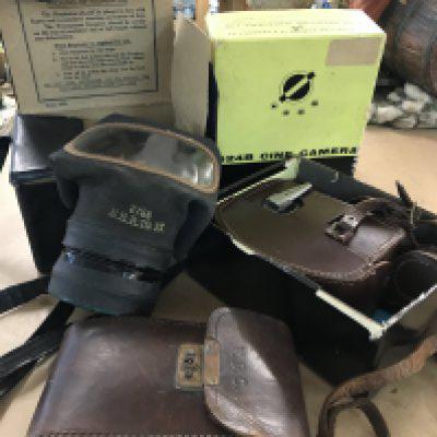 A WWII respirator in original box, a Bell & Howell - Cine Camera with instruction with instruction leaflets and wide angle attachments. In original box and leather case, together with an IHAGEE- German Camera-105/4.5 lens in original leather case