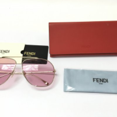 A pair of Fendi sunglasses with pink lenses. Comes with case pouch and card.