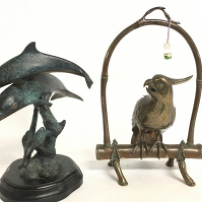 A copper parrot figure and a bronze dolphin figure group. Postage catC