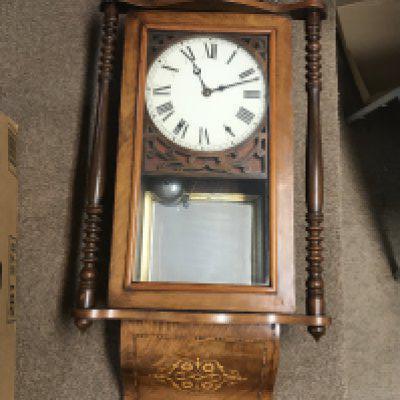 An inlaid walnut wall clock, dimensions 15x82x40cm. This lot cannot be posted