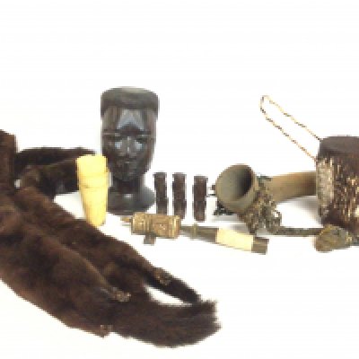 A collection of items including a tribal wooden carved bust, small figures and a drum. Rigi Kulm cups, two Mink pelts, bone prayer wheel etc. this lot cannot be posted. NO RESERVE