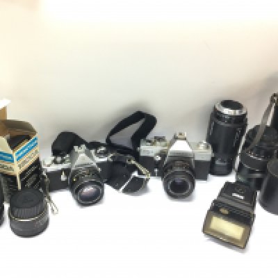A collection of vintage cameras including Pentax ME , Praktica MTL3 and lenses. Postage category D. NO RESERVE
