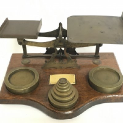 A set of brass office beam balance scales with a set of weights. This lot cannot be posted.