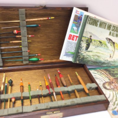 A vintage Box of fishing floats and some books. Postage category c. NO RESERVE