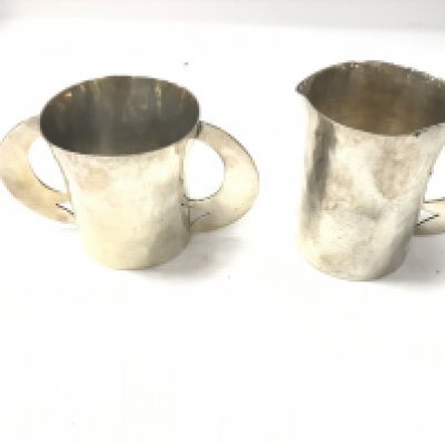 A white metal jug and double handled mug with hammered finish effect. 416.80g- NO RESERVE