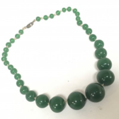 A green jade coloured bead necklace of graduating size.- NO RESERVE