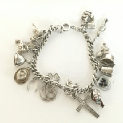 A silver charm bracelet including some enamel charms. Postage category A- NO RESERVE