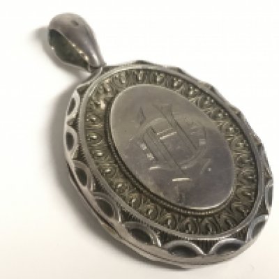 A Victorian silver locket pendant. Postage category A- NO RESERVE