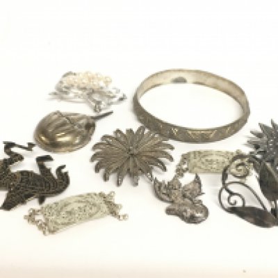 A collection of silver jewellery including brooches and a bangle. 100g in total. postage category A- NO RESERVE