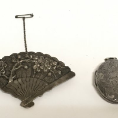 A Chinese silver fan brooch and a silver locket. Postage category A- NO RESERVE