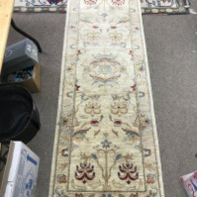 A hand tied wool hall runner rug. 182cm by 64 cm approx. NO RESERVE