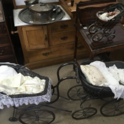 Two vintage dolls prams and a small pram with doll.