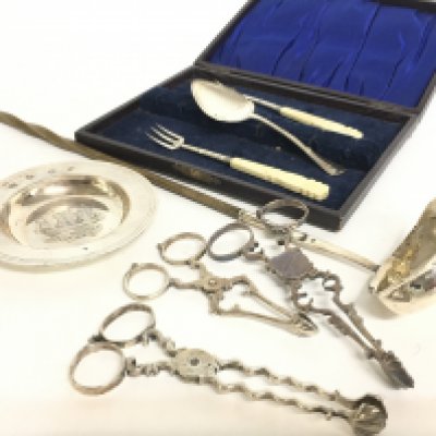 A collection of silver hallmarked items including a dish, a silver hallmarked ladle, sugar snips, cutlery etc. postage category C