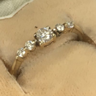 An 18ct yellow gold ring inset with a row of five small diamonds