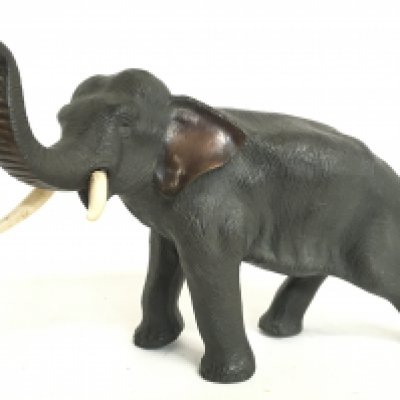 A Meiji period Japanese bronze elephant figure with bone tusks, 18cm tall. Postage category C