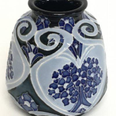 A Moorcroft forget me not vase, 8cm tall. No obvious damage or restoration, this lot cannot be posted.