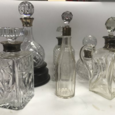 A collection of six Hallmarked silver collared decanters.