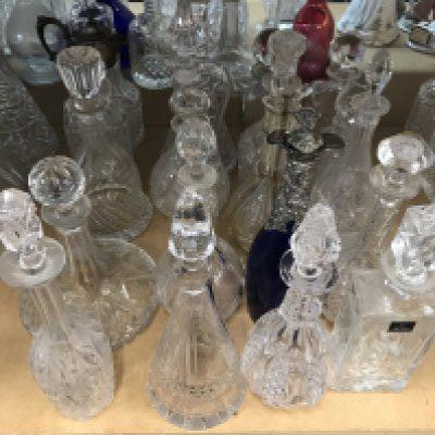 A large collection of decanters including some silver plated and cut glass examples. Approx 20 decanters.