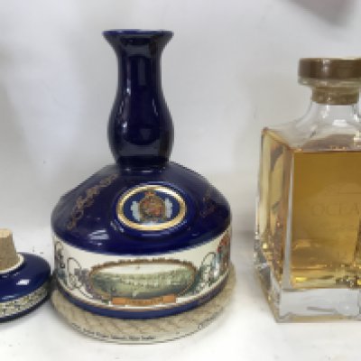 A ceramic bottle of rum and a oceana 12 year aged bottle of single malt whiskey.