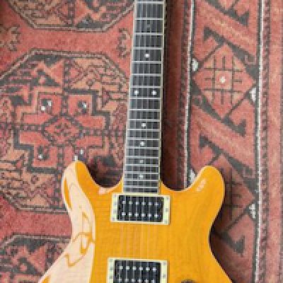A 2000 Yamaha MSG Deluxe electric guitar with Yellow Flame Top HB Pickups and locking vibrato tremolo system. Good condition overall with one small varnish chip to neck rear.