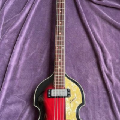 A Sekova Lawsuit era Japanese manufactured bass guitar designed to be a replica of a Hofner Beatle Bass. Average condition with black plastic hard type case.