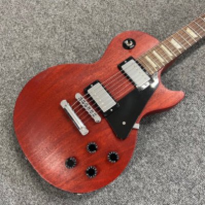 A 2009 Gibson Les Paul Studio electric guitar in natural mahogany finish, all original and in very good largely unplayed condition with very light playwear. Comes in non original case