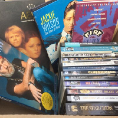 A box of DVDs and CD long box sets by various artists including Abba, Jackie Wilson, Willie Nelson and others.